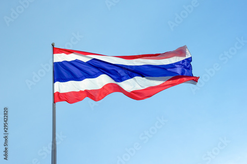 Flag of Thailand under blue sky