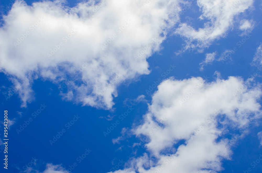 Blue sky with white clouds. Plain landscape background for summer poster design.
