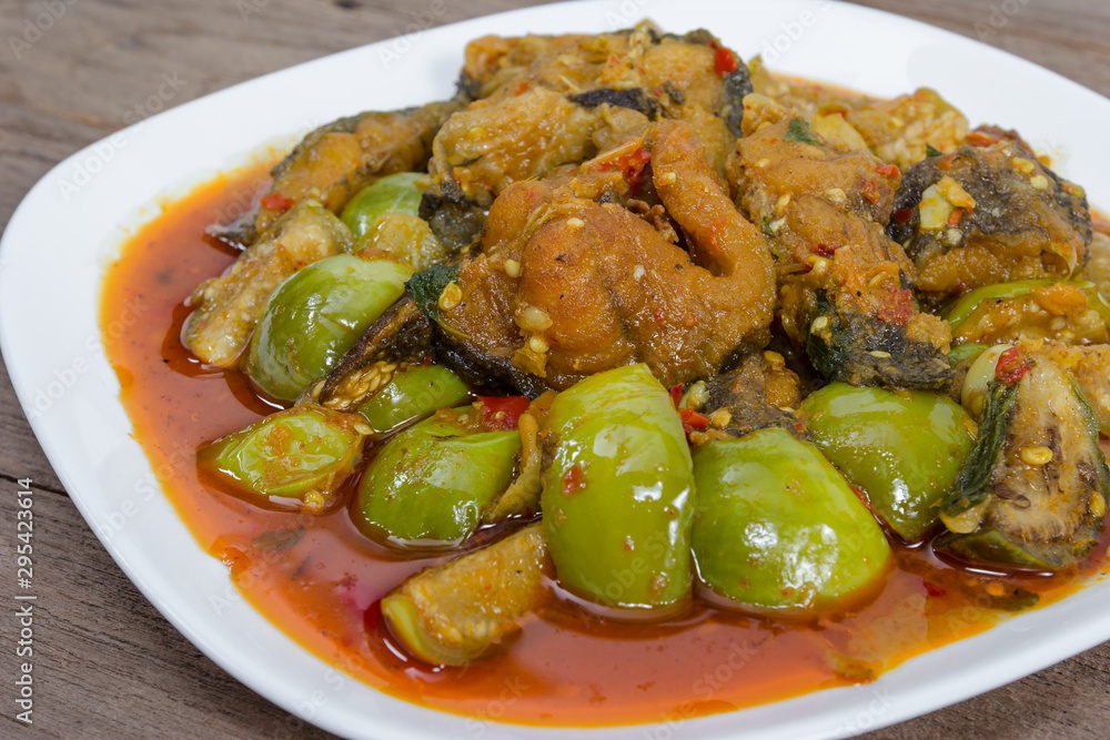 Spicy Fried Stir Catfish on wood background