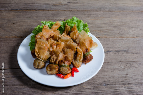 fried wonton or Toong Tong isolated on wood background