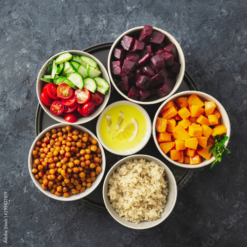 Healthy vegetarian ingredients for cooking moroccan salad. Chickpeas, Baked pumpkin and beets, quinoa and vegetables top view copy space