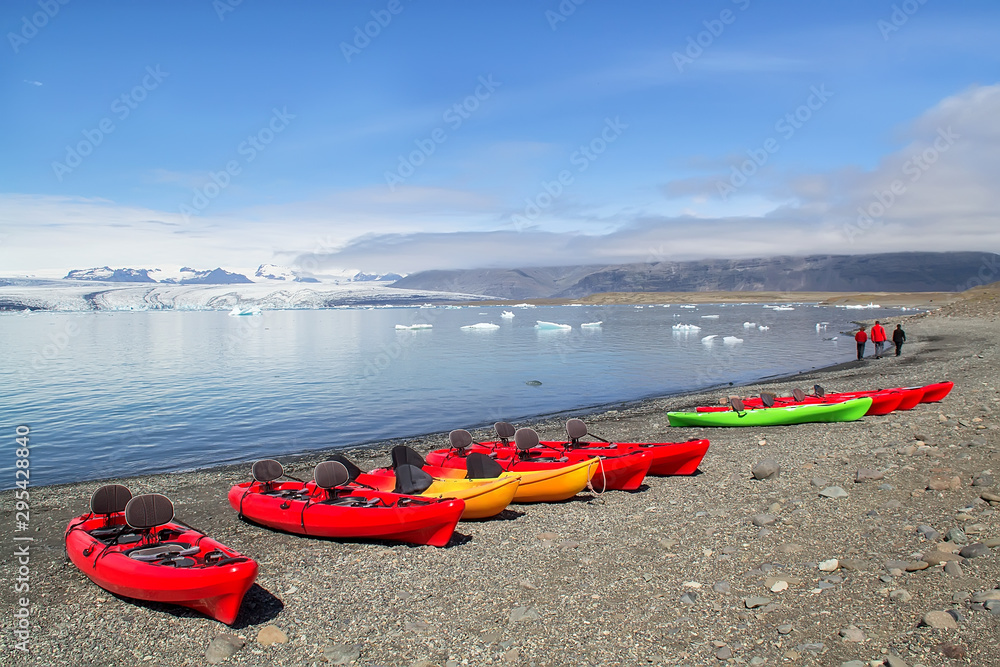 Fototapeta premium Kayaks on the shore of Jokulsarlon glacier lagoon, south Iceland, Europe. Selective focus