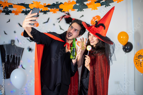 happy couple of love  in costumes and makeup on a celebration of Halloween