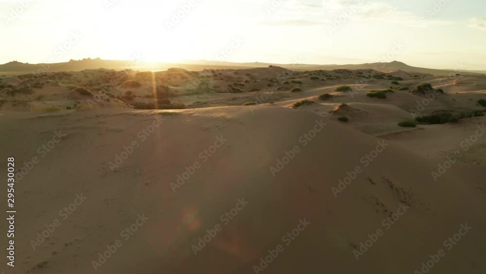 Sunset over the sand dunes in the desert Sunset over the sand dunes in the desert