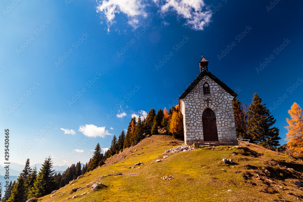 The Madonna della neve church in a colorful autumn