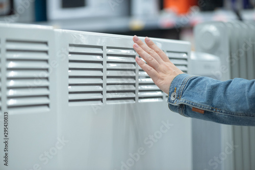 Woman is choosing a new heater for home.