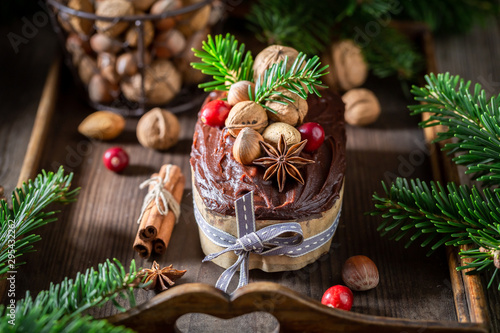 Sweet and homemade gingerbread nuts for Christmas decorated with spruce