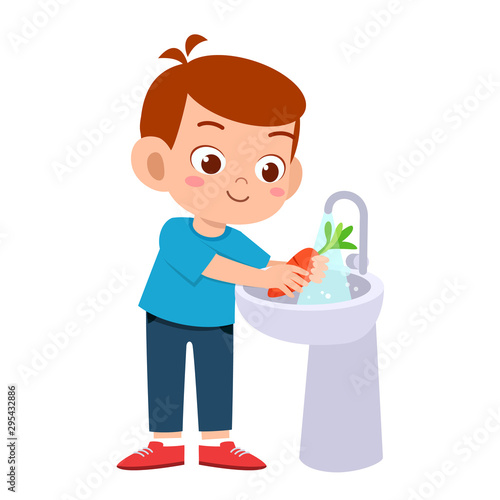 happy cute kid boy wash vegetable fruit clean