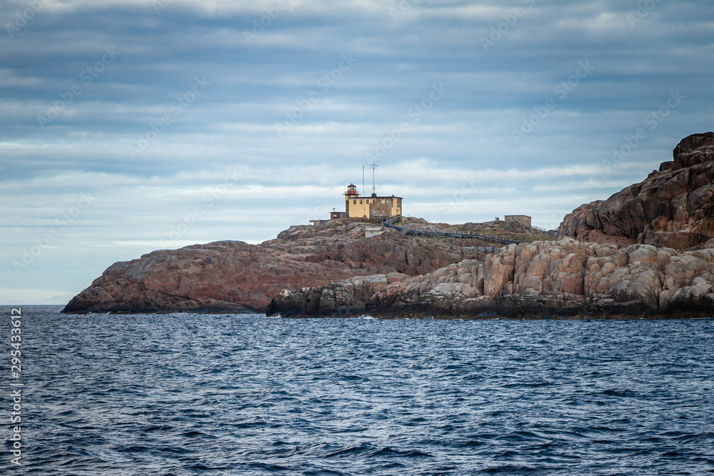 Lighthouse on the rocks. Teriberka. Coast of the Arctic Ocean. Russia.