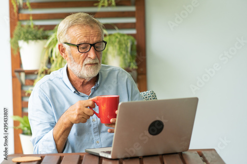 Portrait senior man using laptop for working at home, Freelance concept - Image
