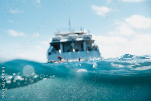 Great barrier reef, Australia: Cruise boat in the middle of the ocean, underwater photo, half/half #295433818