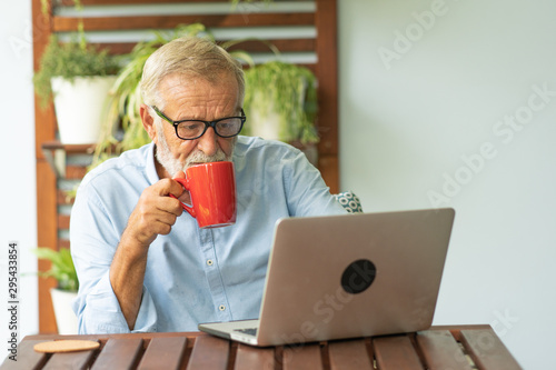 Portrait senior man using laptop for working at home, Freelance concept - Image