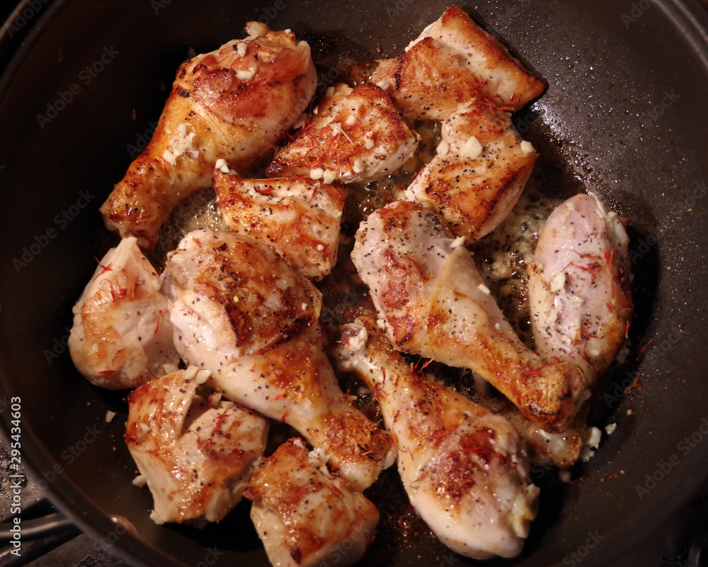 Pan with chicken parts being fried for a tasty dinner dish Pan with chicken parts being fried for a tasty dinner dish