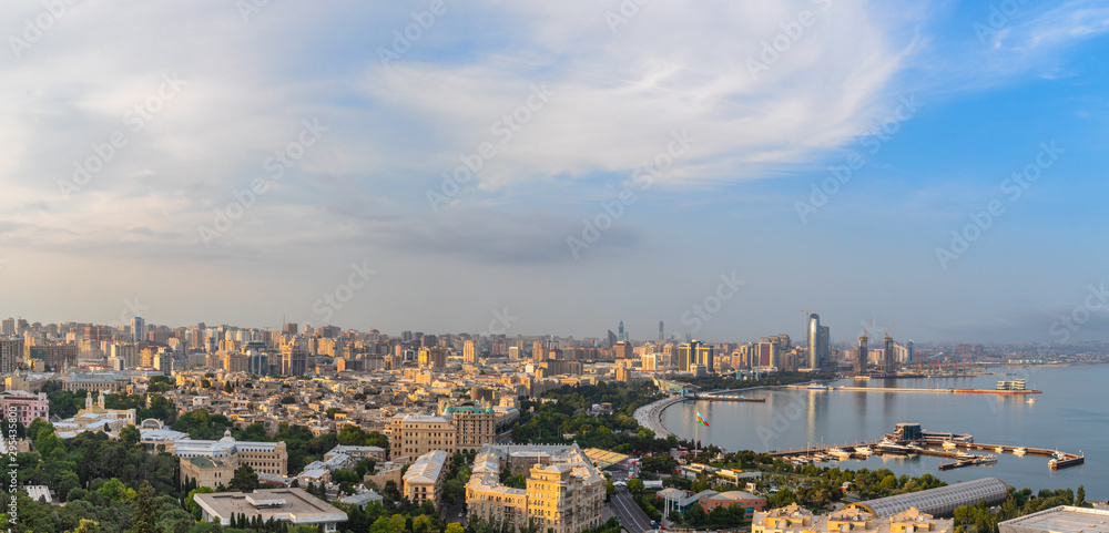 Overview panorama of central city business district at the bay with marina and residential suburbs in sunset rays, Baku, Azerbaijan