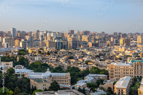 Overview panorama of central city business district and residential suburbs in sunset rays, Baku, Azerbaijan