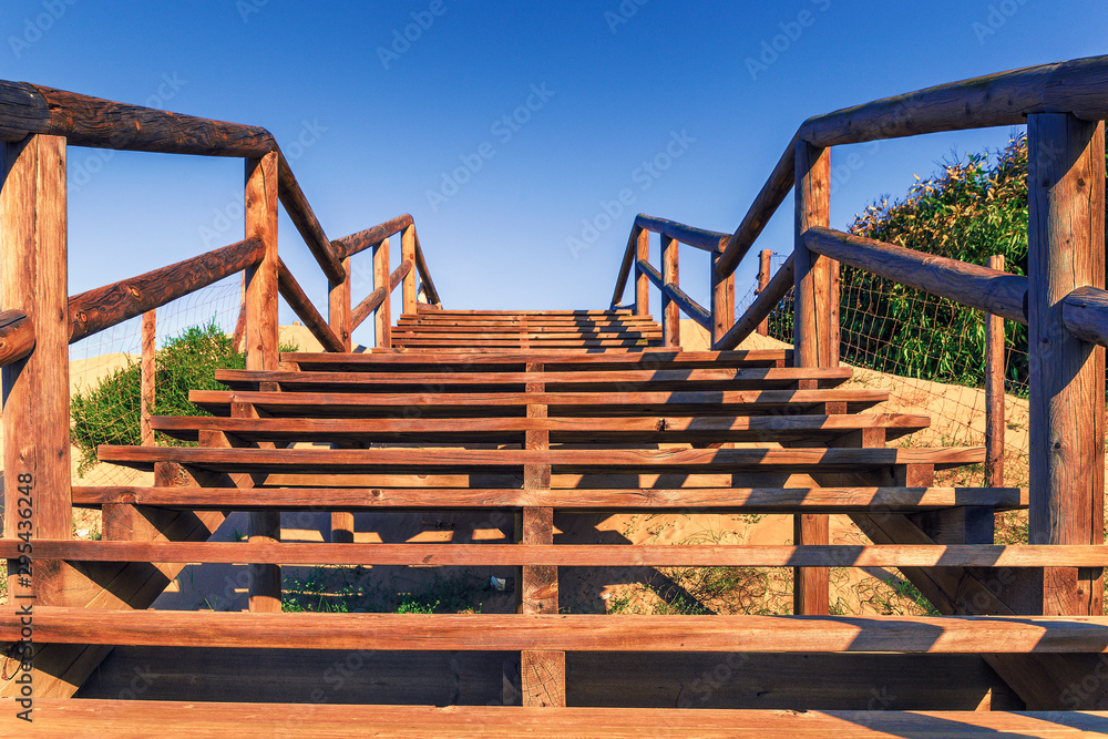 wooden stairs over the dunes to access the Guardamar beach. Alicante, Spain wooden stairs over the dunes to access the Guardamar beach. Alicante, Spain