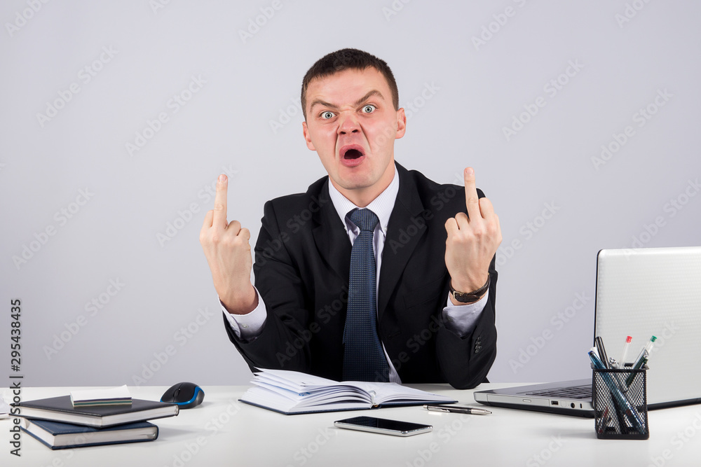 Office, finances, internet, business, success and stress concept-Angry businessman showing you the middle fingers Office, finances, internet, business, success and stress concept-Angry businessman showing you the middle fingers