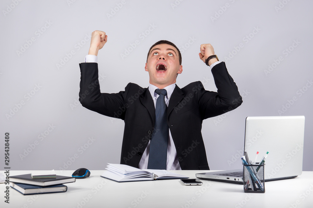 Office, finances, internet, business, success concept-happy young businessman with his arms raised up Office, finances, internet, business, success concept-happy young businessman with his arms raised up