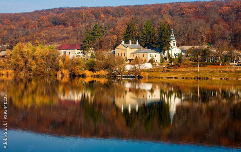 Magnificent landscape with a view of the lake in autumn and the monastery