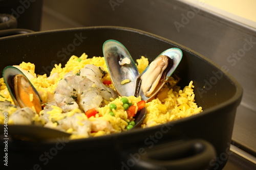 oysters in rice being cooked in a pan photo