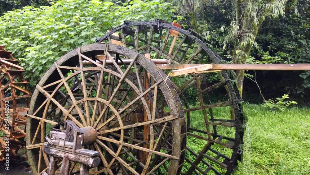 Working and turning old mill wooden water wheels in Huanglong Yellow Dragon Cave scenic area, Zhangjiajie, Hunan, China Working and turning old mill wooden water wheels in Huanglong Yellow Dragon Cave scenic area, Zhangjiajie, Hunan, China