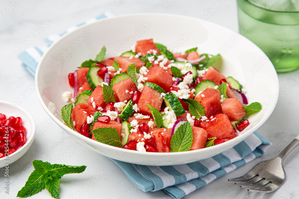Watermelon, cucumber, feta and mint salad in white bowl Watermelon, cucumber, feta and mint salad in white bowl