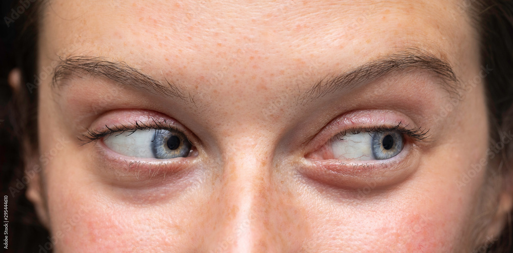 Fototapeta premium Female blue eyes looking to side close up