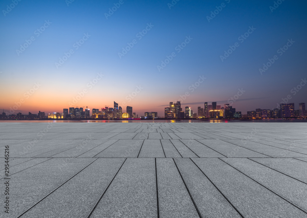 Panoramic skyline and buildings with empty square floor at dusk