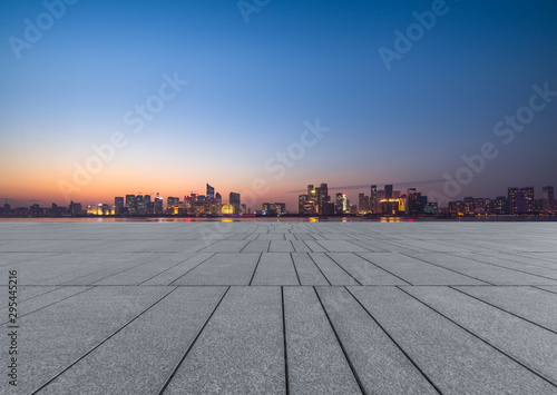 Panoramic skyline and buildings with empty square floor at dusk