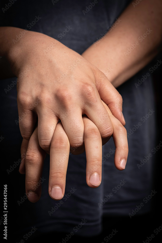 Human with fingers interlocked close up