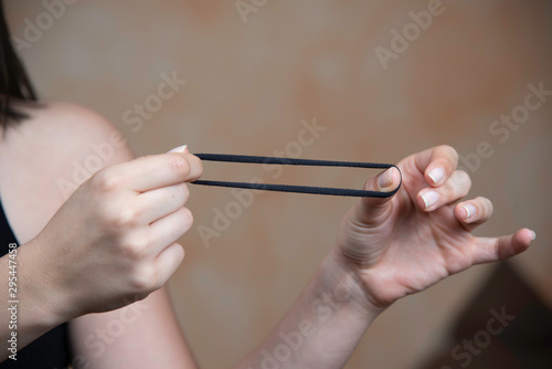 Принти на полотні Woman stretching hair scrunchy in hands