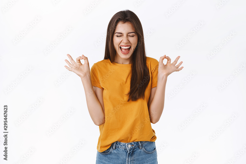 Excited, cheerful lucky girl believe everything be okay, close eyes scream delighted and thrilled, showing ok, perfection or approval sign, smiling anticipating awesome party, white background Excited, cheerful lucky girl believe everything be okay, close eyes scream delighted and thrilled, showing ok, perfection or approval sign, smiling anticipating awesome party, white background