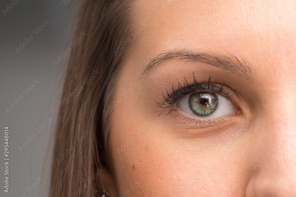 Woman with green color eye iris close up Woman with green color eye iris close up