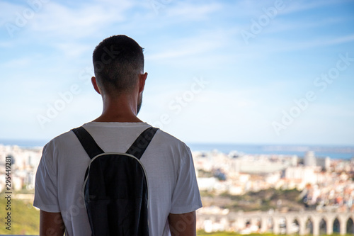 A man admires Lisbon from the Panoramico de Monsanto, a building built in the sixties as a restaurant, now abandoned, a popular place for photography enthusiasts.