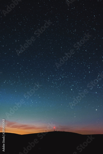 Glowing town in the mountains with the milky way galaxy and panorama mountain. view. Wurmberg  Braunlage Harz National Park  German Mountain