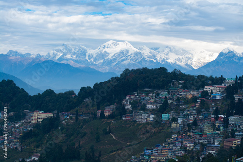Darjeeling City on hill with mountains and clouds background, India