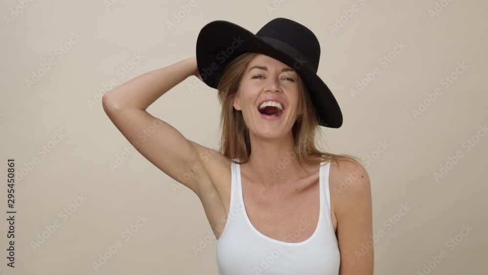 Medium Shot of a Woman Giggling while Wearing Black Sun Hat Medium Shot of a Woman Giggling while Wearing Black Sun Hat