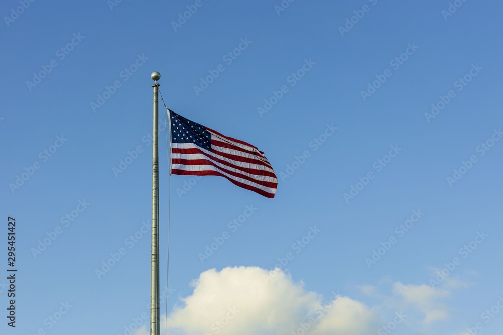 Beautiful view of American flag blue sky with white clouds background.