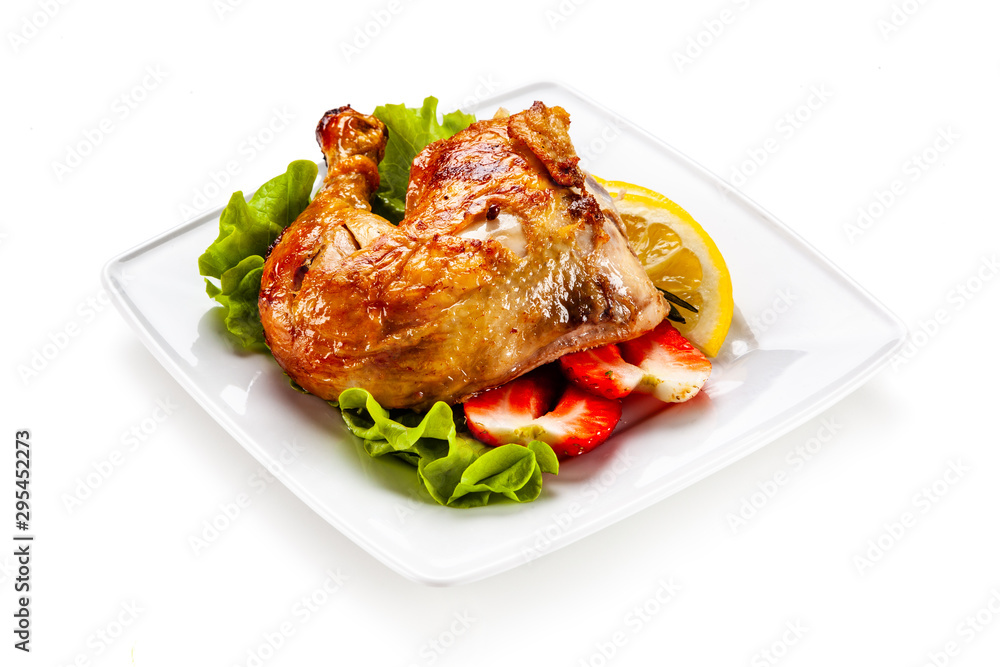 Grilled chicken leg with vegetables on white background Grilled chicken leg with vegetables on white background