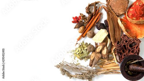 Chinese herb selection used in traditional alternative herbal medicine with mortar and pestle on white background.