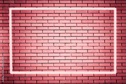 bright neon pink frame on a brick pink wall as a template for design. Trendy concept, space for text 