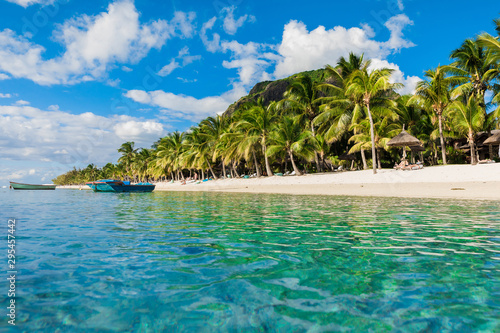 Luxury beach in Mauritius. Transparent ocean  white sand beach  palms and sky