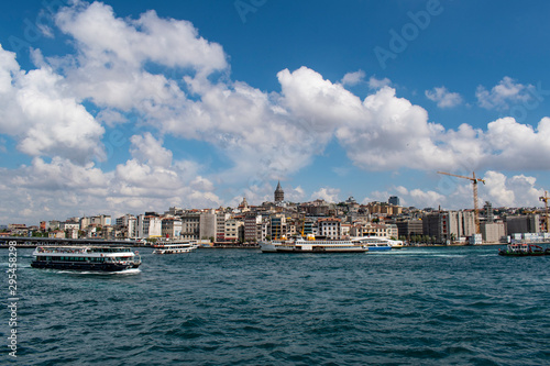 Istanbul, Turkey: the breathtaking skyline with the Galata Tower and a ship crossing the Bosphorus for a cruise in the Strait of Istanbul, part of the continental boundary between Europe and Asia © Naeblys