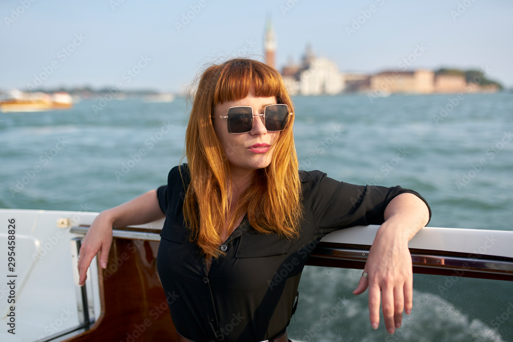 cowboy boots standing on yacht 