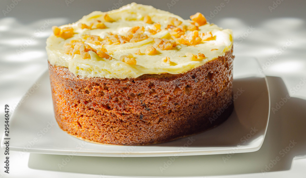 Carrot cake filled and topped with cream cheese buttercream and decorated with walnuts Carrot cake filled and topped with cream cheese buttercream and decorated with walnuts