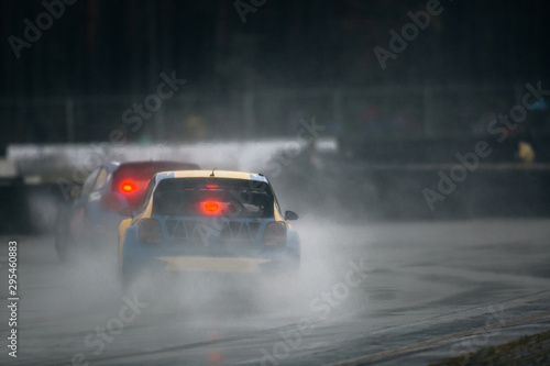 Rally cross cars ride fast during rain