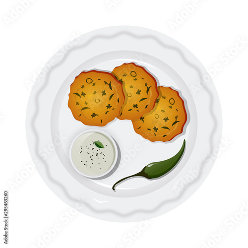 Delicious Karnataka snack Maddur Vada with coconut sauce (Chutney) and green chilli on plate.