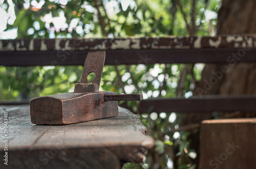 Old carpentry planer, vintage wood planer, on a wooden table.