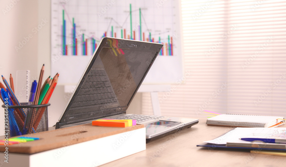 Office table with blank notepad and laptop Office table with blank notepad and laptop
