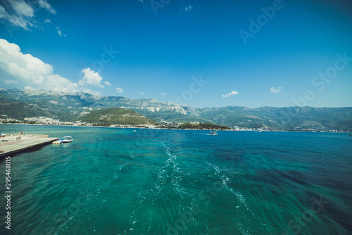 Adriatic coast in summer. The height of the tourist season. Transparent warm sea and mountains. Montenegro.